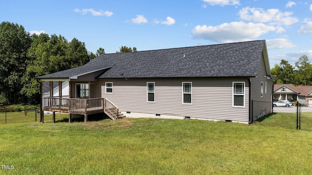 rear view of house with a yard and a wooden deck