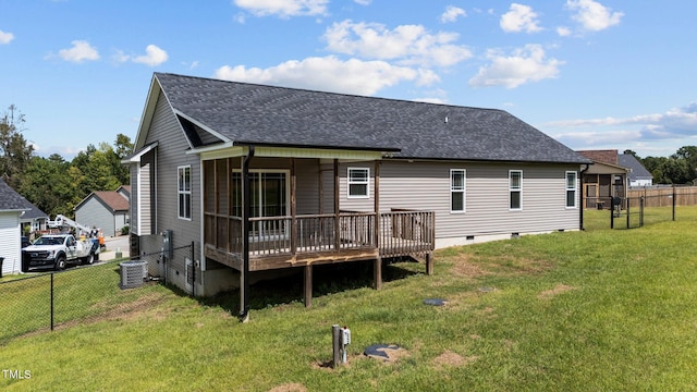 rear view of house with a yard, cooling unit, and a deck