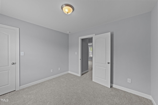 unfurnished bedroom with light colored carpet