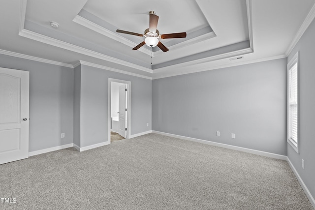 unfurnished bedroom featuring ornamental molding, multiple windows, and a raised ceiling