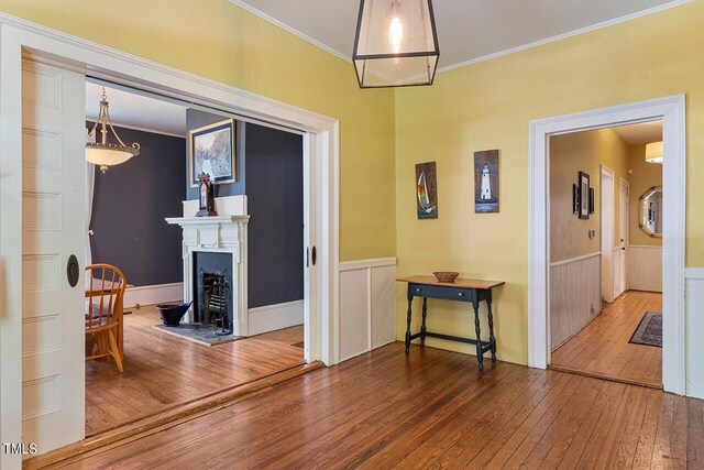 hall with crown molding and hardwood / wood-style flooring