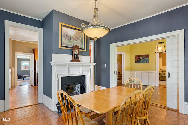 dining room with ornamental molding and hardwood / wood-style floors