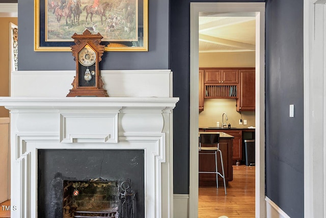 214 College St, Oxford, NC 27565 - details with beam ceiling, a fireplace, and wood finished floors