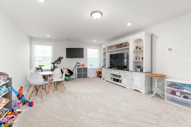 recreation room featuring baseboards, recessed lighting, and light colored carpet