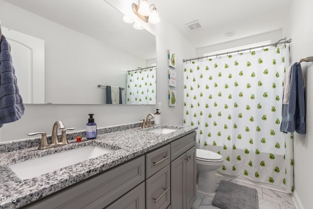 bathroom with toilet, marble finish floor, visible vents, and a sink