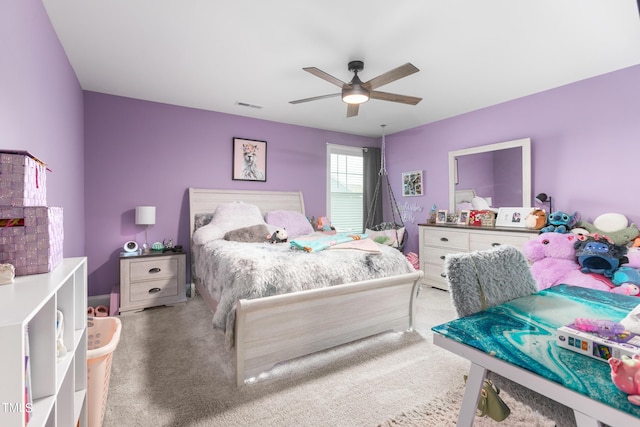 carpeted bedroom featuring visible vents and ceiling fan