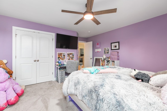 bedroom featuring ceiling fan, a closet, and light colored carpet