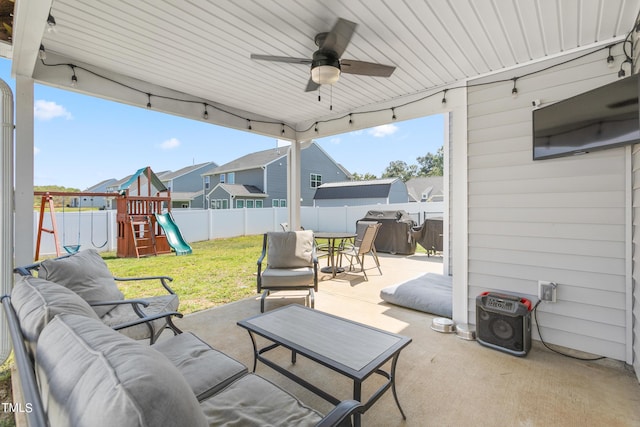 view of patio / terrace featuring ceiling fan, outdoor dining area, a playground, a fenced backyard, and an outdoor hangout area