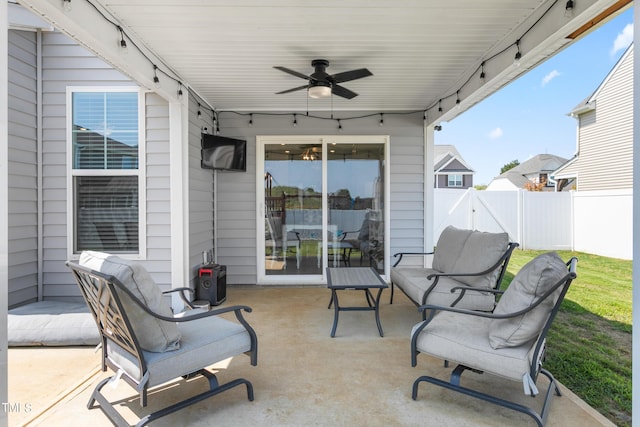 view of patio with a ceiling fan and fence