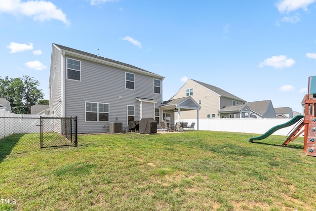 back of property featuring a patio, a yard, a playground, and a fenced backyard