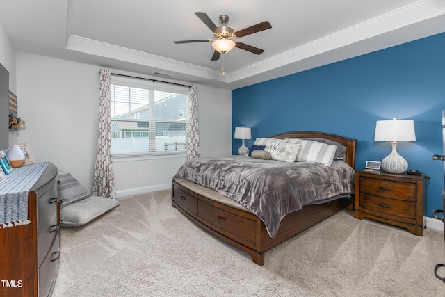 bedroom featuring baseboards, ornamental molding, a raised ceiling, and carpet flooring