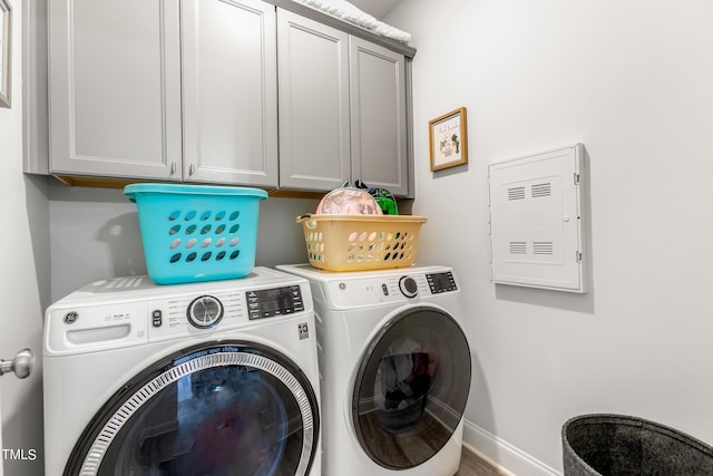 laundry room with cabinet space, independent washer and dryer, and baseboards