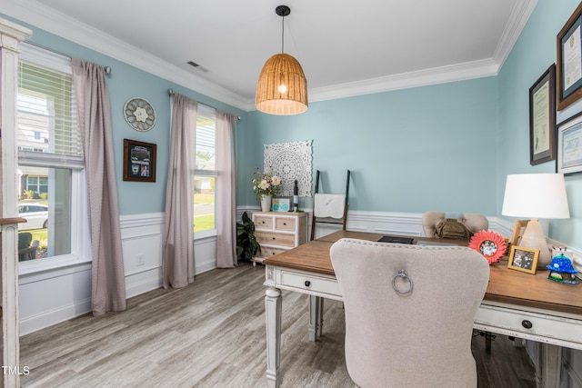 office with light wood-style floors, wainscoting, visible vents, and ornamental molding