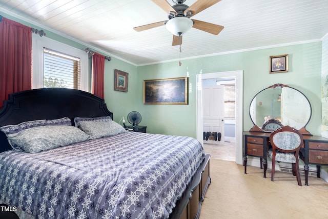 bedroom with ornamental molding, light colored carpet, and ceiling fan