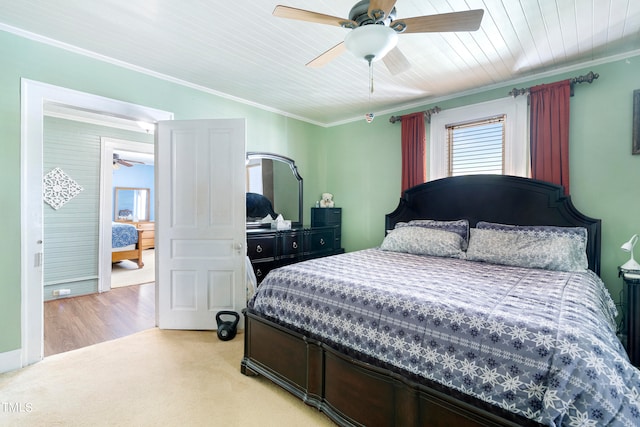 bedroom with crown molding, ceiling fan, and light carpet