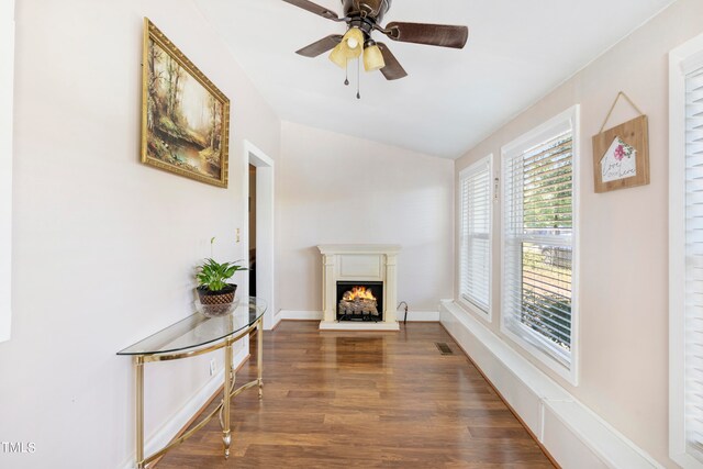 sitting room featuring ceiling fan, dark hardwood / wood-style floors, and vaulted ceiling