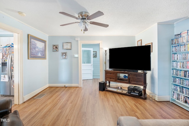 living room with ceiling fan, crown molding, a textured ceiling, and light hardwood / wood-style flooring