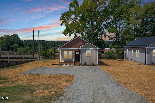 view of front of property featuring a yard and covered porch