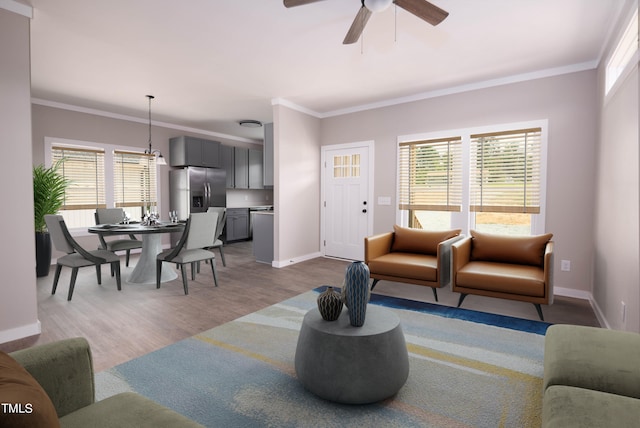 living room with light wood-type flooring, ceiling fan, plenty of natural light, and ornamental molding