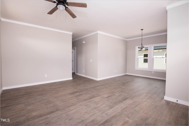 unfurnished living room featuring ceiling fan with notable chandelier, dark hardwood / wood-style flooring, and ornamental molding