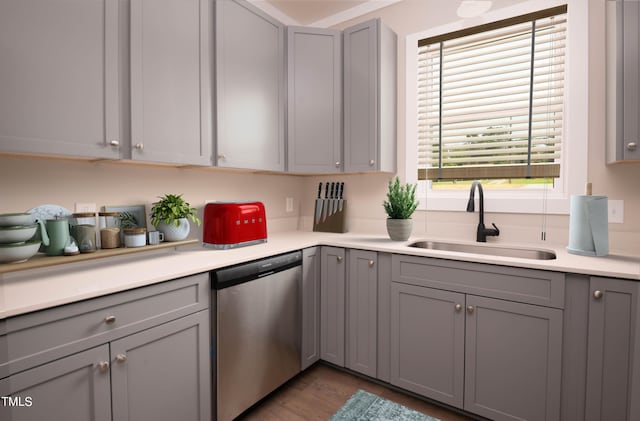 kitchen with dishwasher, hardwood / wood-style floors, gray cabinets, and sink