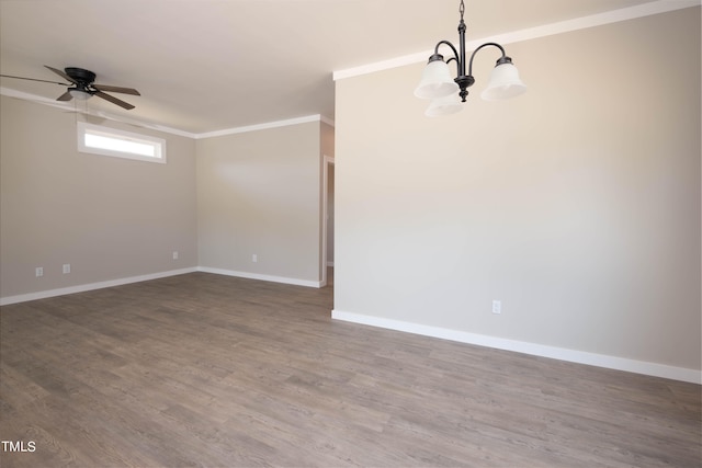 empty room featuring ornamental molding, hardwood / wood-style floors, and ceiling fan with notable chandelier