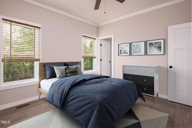 bedroom featuring crown molding, hardwood / wood-style flooring, and ceiling fan