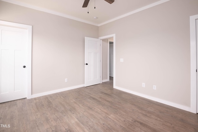 empty room with crown molding, ceiling fan, and hardwood / wood-style floors