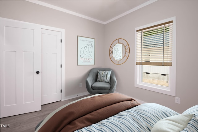 bedroom featuring crown molding, multiple windows, and wood-type flooring