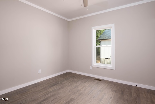 unfurnished room featuring ceiling fan, dark hardwood / wood-style flooring, and ornamental molding