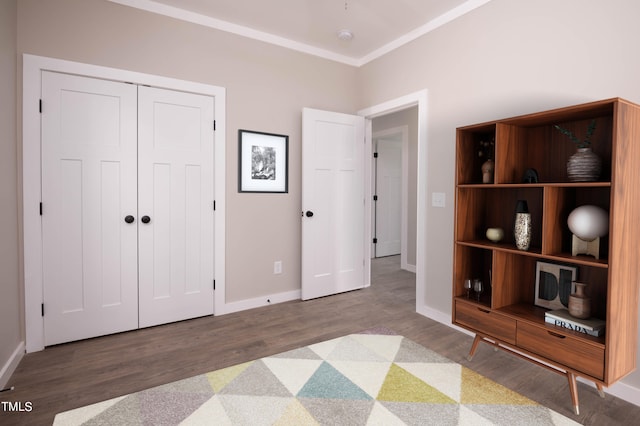 unfurnished bedroom featuring ornamental molding, a closet, and wood-type flooring