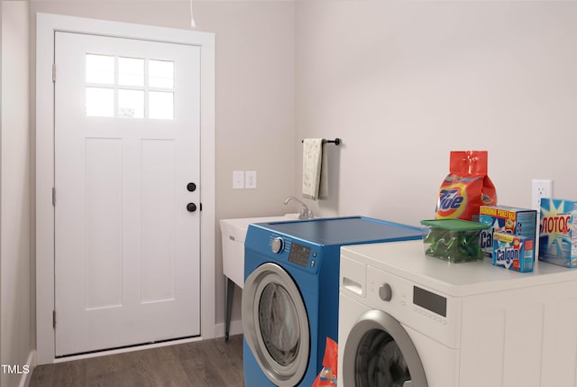 washroom featuring dark hardwood / wood-style flooring and washer and clothes dryer