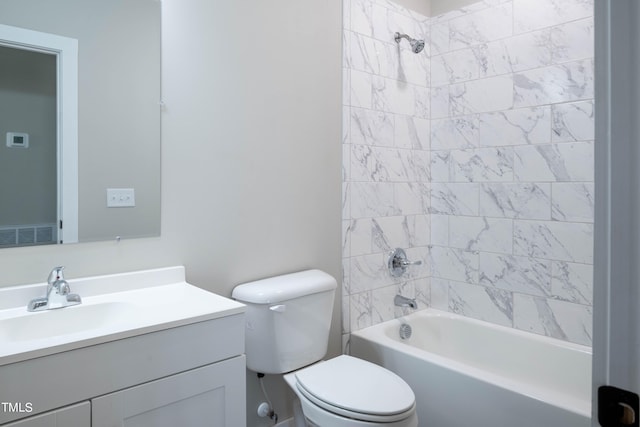 full bathroom featuring tiled shower / bath combo, vanity, and toilet