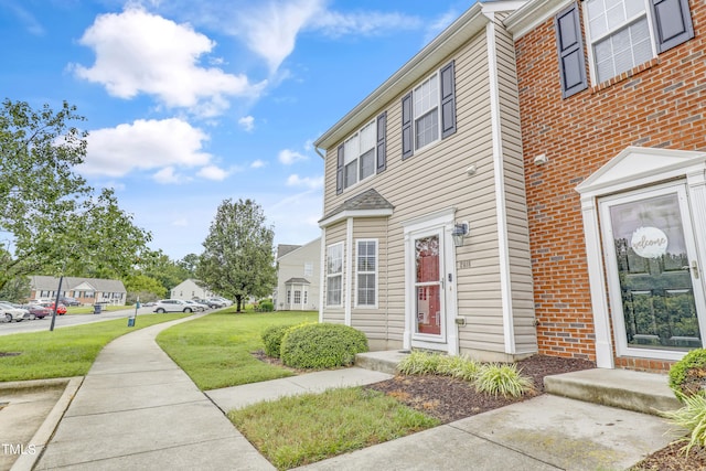 view of side of property with a lawn