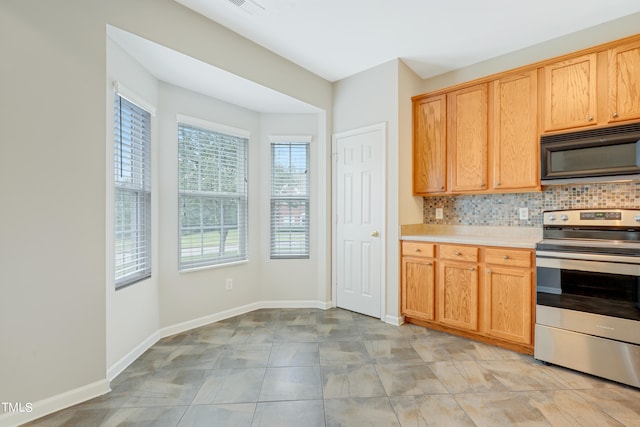 kitchen with tasteful backsplash, stainless steel stove, and light tile patterned floors