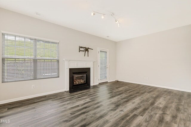 unfurnished living room featuring hardwood / wood-style floors