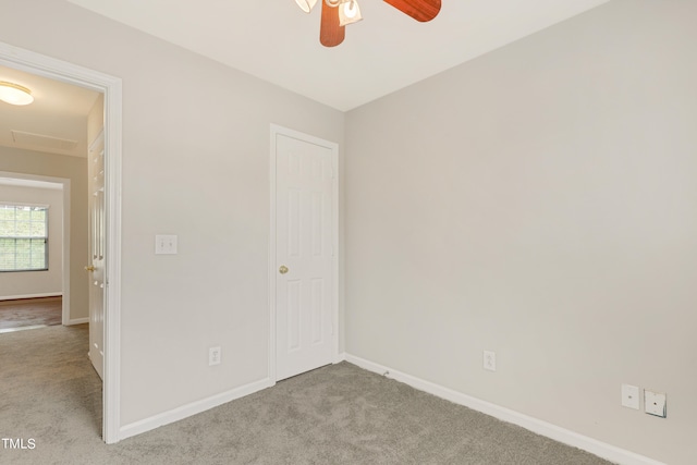 interior space featuring light colored carpet and ceiling fan