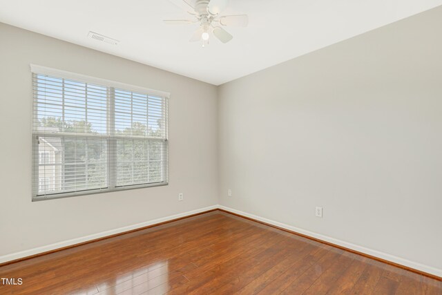 spare room with hardwood / wood-style floors and ceiling fan