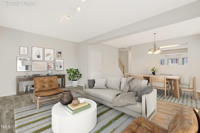 living room with a chandelier and light wood-type flooring