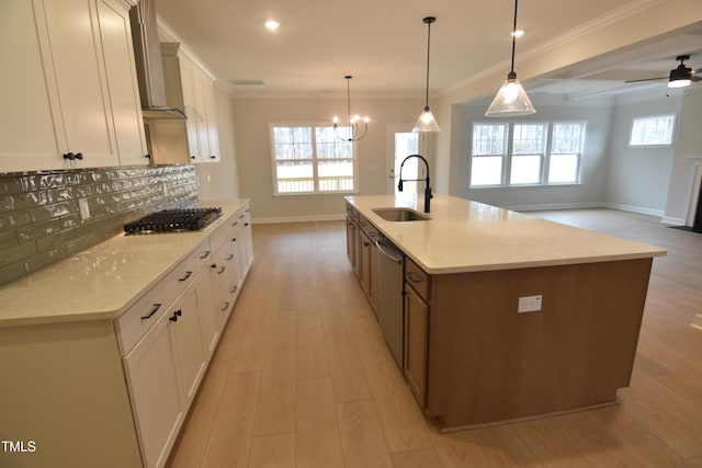 kitchen with a large island, white cabinetry, sink, and stainless steel appliances