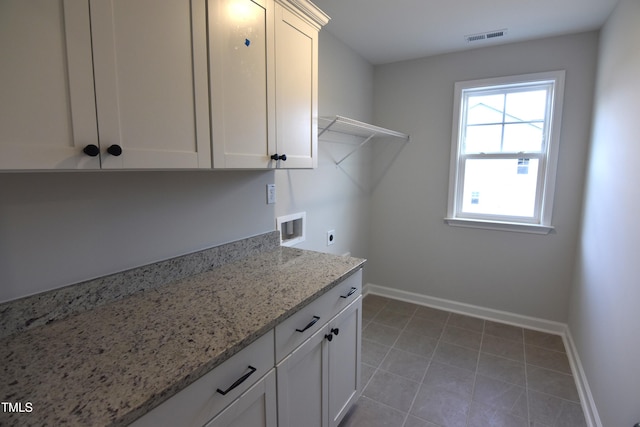 laundry room featuring cabinets, hookup for a washing machine, hookup for an electric dryer, and light tile patterned flooring