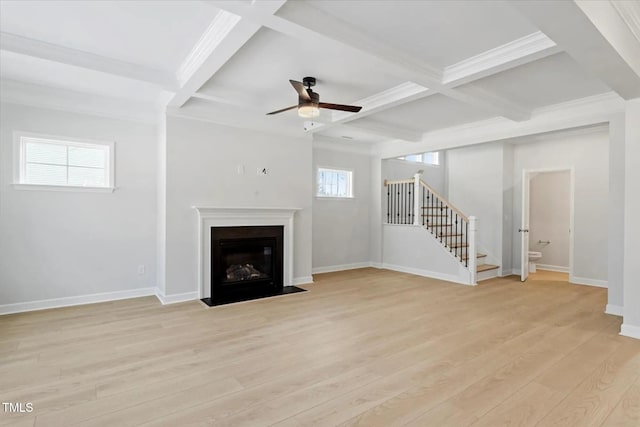 unfurnished living room featuring light wood-style floors, a fireplace with flush hearth, stairs, and baseboards