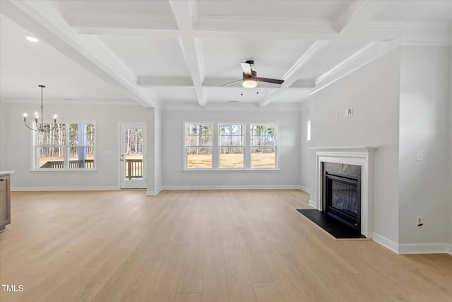 unfurnished living room with beam ceiling, a fireplace, light wood-style flooring, and baseboards