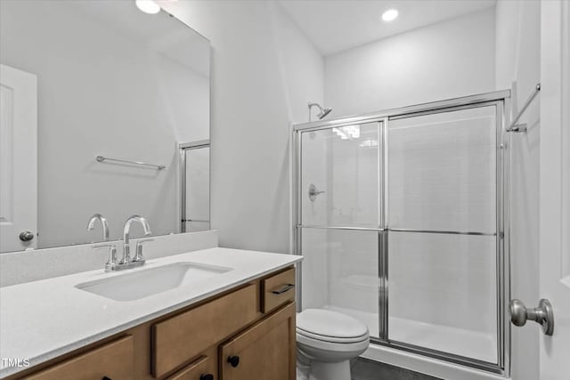 full bathroom with recessed lighting, toilet, vanity, and a shower stall