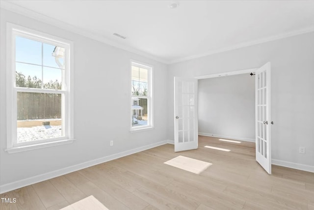 unfurnished bedroom featuring light wood-style flooring, visible vents, ornamental molding, and french doors