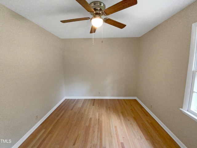 unfurnished room with ceiling fan and wood-type flooring