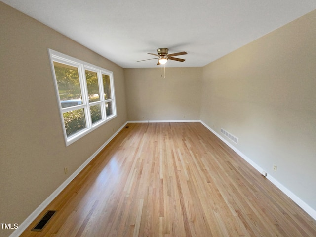 empty room with light hardwood / wood-style flooring and ceiling fan