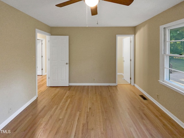 spare room featuring light wood-type flooring and ceiling fan