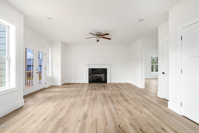 unfurnished living room featuring ceiling fan and light hardwood / wood-style floors