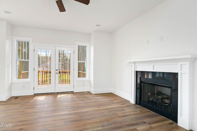 unfurnished living room featuring lofted ceiling, wood-type flooring, and ceiling fan